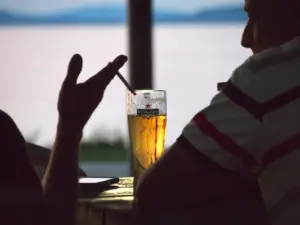 Phone and drink on a table at dusk, illustrating fast relief and choices in ADHD and addiction